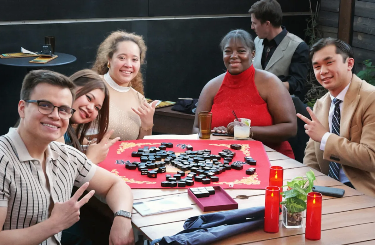 Friends enjoying a game of mahjong at an Asia XP community gathering